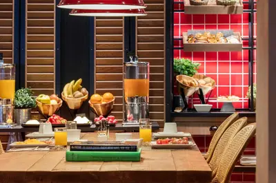 a table with chairs and a buffet of food at Casa Elliot Hotel in Barcelona
