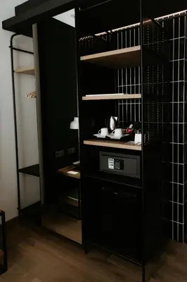 a kitchen with a black cabinet with a stove at Casa Elliot Hotel in Barcelona