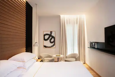 a hotel room with a bed and a window at Casa Elliot Hotel in Barcelona