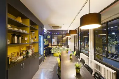 a restaurant with a long table and chairs at Free Hostels Barcelona in Barcelona