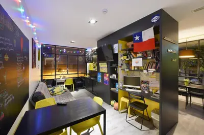 a room with a table and chairs and a desk at Free Hostels Barcelona in Barcelona