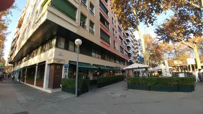a building on the side of a city street at La Ciudadela in Barcelona