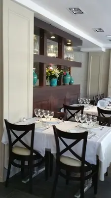 a dining room with tables and chairs with wine glasses at La Ciudadela in Barcelona