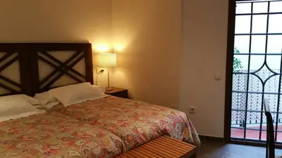 a bedroom with a bed and a large window at La Ciudadela in Barcelona