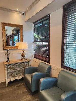 a living room with two chairs and a table and a mirror at La Ciudadela in Barcelona