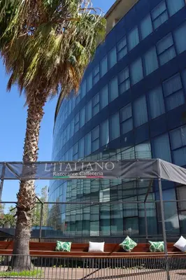 a palm tree in front of a building at Eurohotel Barcelona Granvia Fira in Hospitalet de Llobregat