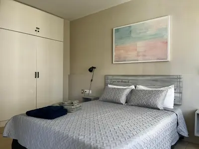 a bedroom with a bed and a painting on the wall at Precioso y tranquilo apartamento zona alta Diagonal Barcelona in Barcelona