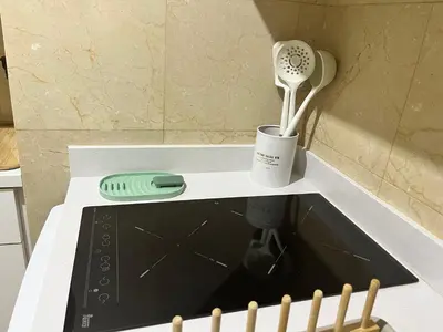 a kitchen counter with a hair dryer and a whisk at Precioso y tranquilo apartamento zona alta Diagonal Barcelona in Barcelona