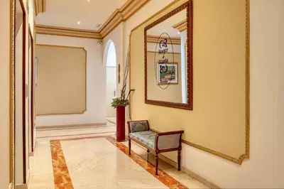 a hotel room with a large bed and a chair at Hotel Roger de Llúria in Barcelona