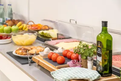 a table topped with food and a bottle of wine at Hotel Glòries in Barcelona
