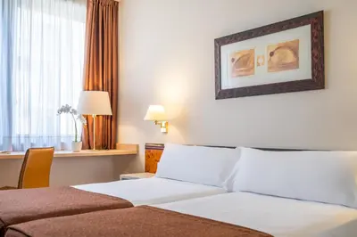 a hotel room with a bed and a window at Hotel Glòries in Barcelona