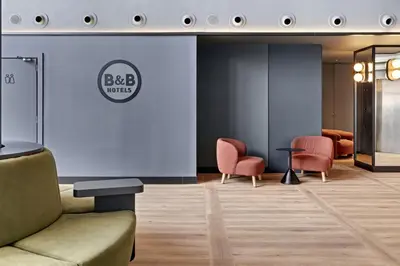 a waiting room with a couch and chairs at B&B HOTEL Barcelona Mollet Porta de Gallecs in Mollet del Vallès
