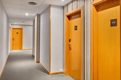 a row of doors in an office hallway at B&B HOTEL Barcelona Mollet Porta de Gallecs in Mollet del Vallès