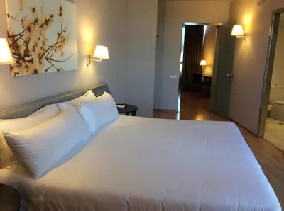 a bedroom with a large white bed with two pillows at Ciutat de Granollers in Granollers