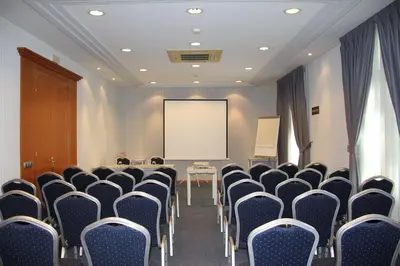 a conference room with chairs and a white screen at Best Western Premier Hotel Dante in Barcelona