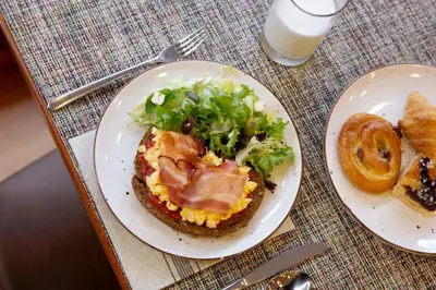 a plate of food with a sandwich on a table at Best Western Premier Hotel Dante in Barcelona