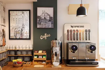 a kitchen with a coffee machine on a counter at Hotel Ronda Lesseps in Barcelona