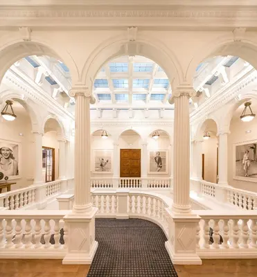 a large room with white columns and a ceiling at Hotel Granvia in Barcelona
