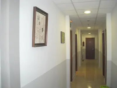 a hallway with white walls and a picture on the wall at Hotel Inglés in Barcelona
