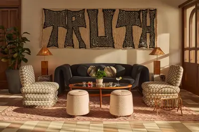 a living room with a couch and two chairs and a table at The Hoxton, Poblenou in Barcelona
