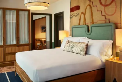 a bedroom with a large bed with a pillow on it at The Hoxton, Poblenou in Barcelona