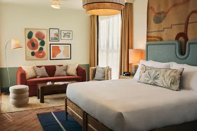 a hotel room with a bed and a couch at The Hoxton, Poblenou in Barcelona