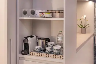 a cupboard with a coffee maker and other kitchen items at Bel Air in Castelldefels