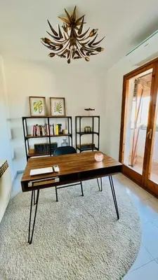 a coffee table in a living room with a chandelier at Mediterranean house, beach and charm garden in Arenys de Mar
