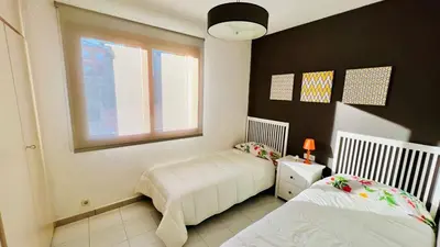 a bedroom with two beds and a window at Mediterranean house, beach and charm garden in Arenys de Mar