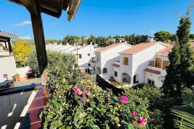 a view from the balcony of a house with pink flowers at Mediterranean house, beach and charm garden in Arenys de Mar