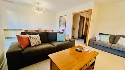 a living room with a couch and a coffee table at Mediterranean house, beach and charm garden in Arenys de Mar