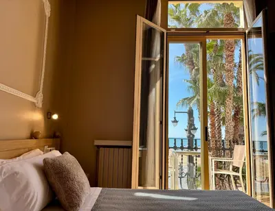 a bedroom with a bed and a view of the ocean at Hotel Celimar in Sitges