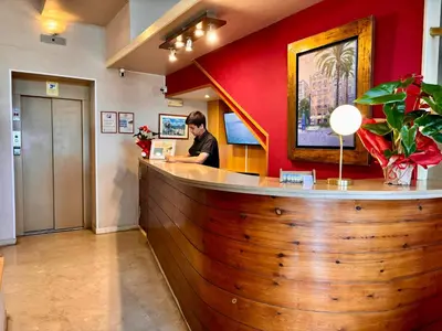 a man sitting at a bar in a restaurant at Hotel Celimar in Sitges