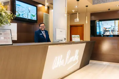 a man standing at the counter of a restaurant at Abba Rambla Hotel in Barcelona