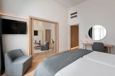 a living room with a couch and a table and chairs at Gran Hotel Havana 4Sup by Escampa Hotels in Barcelona