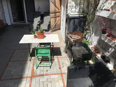 a patio with a table and chairs and a table and a table and chairs at Charming house next to the sea and Barcelona for 6 in Badalona