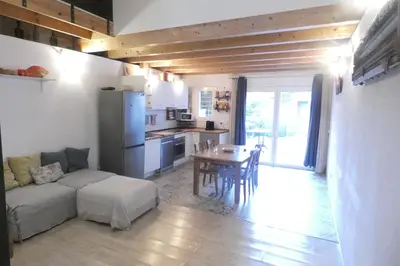 a living room with a couch and a table at Charming house next to the sea and Barcelona for 6 in Badalona