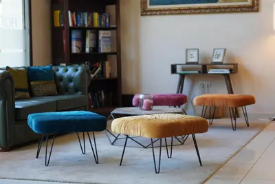 a living room with three chairs and a couch at Espanya - 30º hotels in Calella