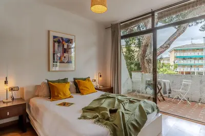 a bedroom with a bed and a large window at Canela Homes COSTA CA NOSTRA in Gavà