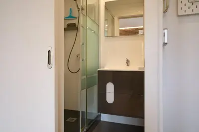 a bathroom with a sink and a glass shower at GuestReady - Acogedor Apt en La Barceloneta in Barcelona