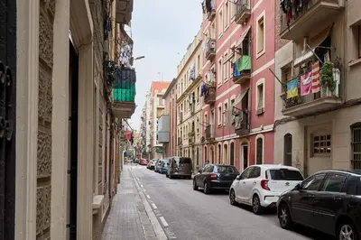a city street with cars parked on the sides of buildings at GuestReady - Acogedor Apt en La Barceloneta in Barcelona