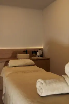 a hotel room with a bed with a towel on it at Gran Hotel Rey Don Jaime in Castelldefels
