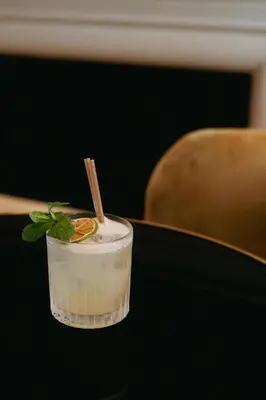 a drink sitting on a table with a stick at Hotel Pulitzer Barcelona in Barcelona
