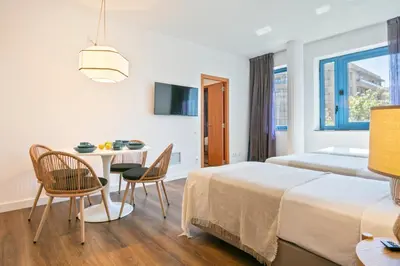 a hotel room with a bed and a table and chairs at Hotel Acta Azul Barcelona in Barcelona