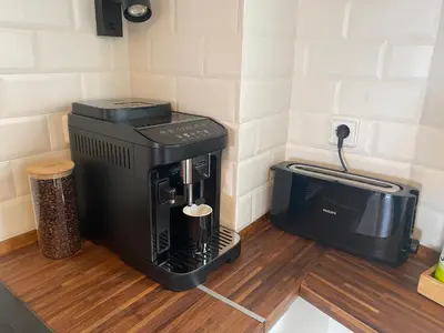 a coffee maker on a counter next to a toaster at La Pastora Lux cerca de Barcelona in Gavà