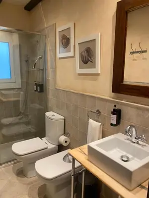 a bathroom with a toilet and a sink and a shower at La Pastora Lux cerca de Barcelona in Gavà