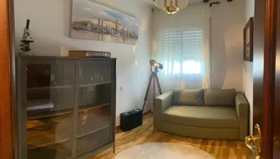 a living room with a couch and a camera at La Pastora Lux cerca de Barcelona in Gavà