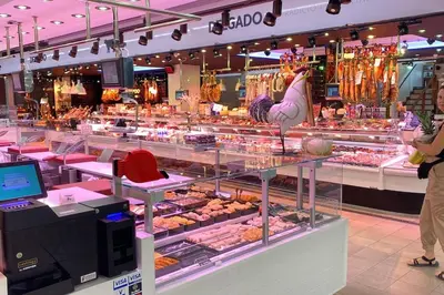 a woman standing in front of a display case in a store at La Pastora Lux cerca de Barcelona in Gavà