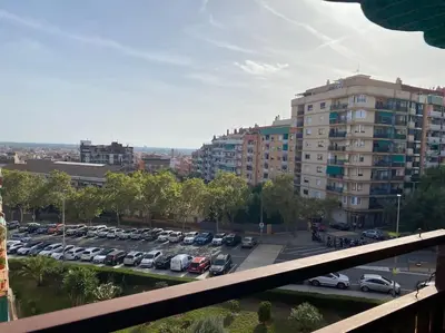 a parking lot with cars parked in a parking lot at La Pastora Lux cerca de Barcelona in Gavà