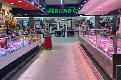 a woman in a store aisle of a supermarket at La Pastora Lux cerca de Barcelona in Gavà